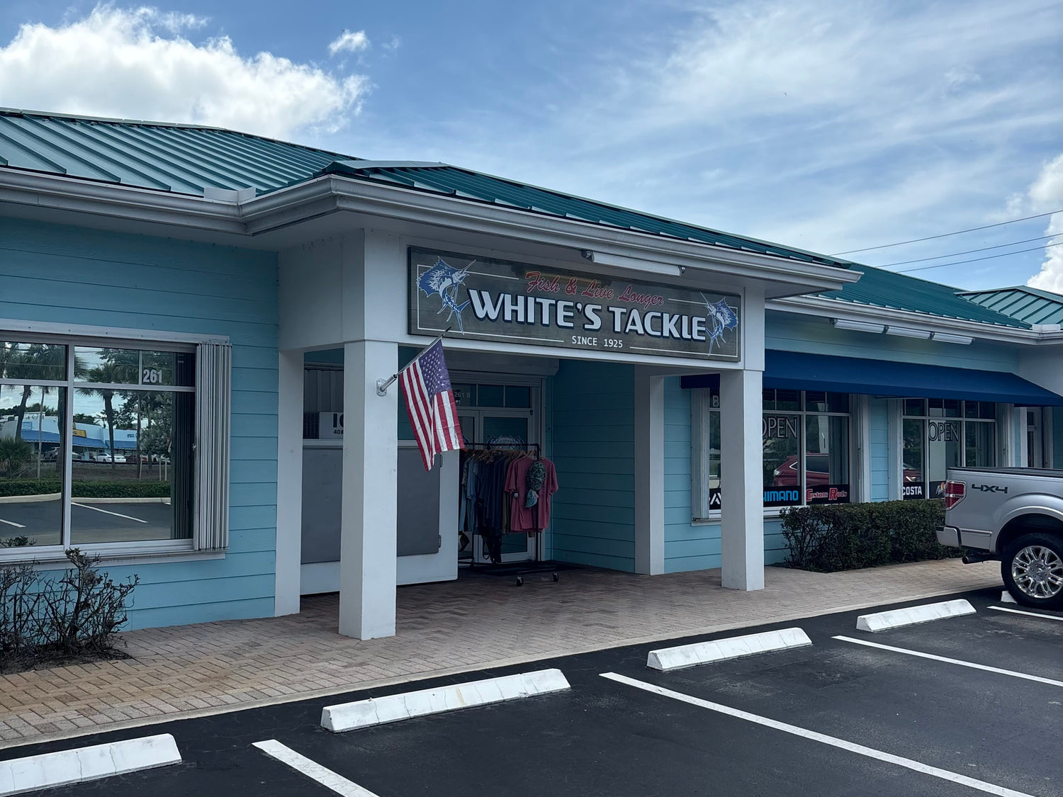 White's Tackle store front with a blue roof and American flag.