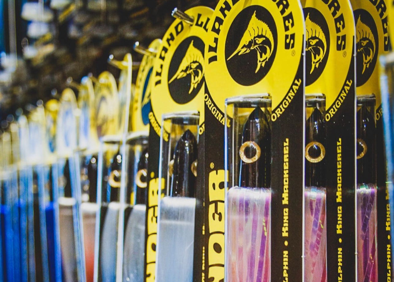 Row of fishing lures with iLand Lures branding in a store setting.